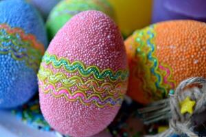 Colorful easter eggs with flowers in the plate. Beautiful easter background. Easter card. Homemade holiday decor. photo