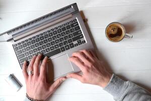 Man working at a laptop, additional business form background, mobile phone laptop operation business photo