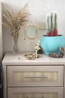 The interior of bedroom. The nightstand with home decor. photo