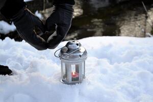 Candle lantern on the snow. photo