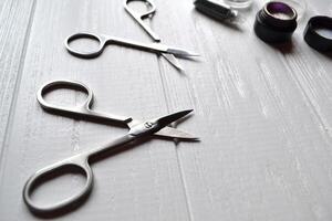 Tools for manicure. Manicure scissors on the white background. photo