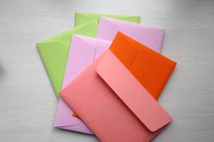 Bright colorful envelopes on the table. photo