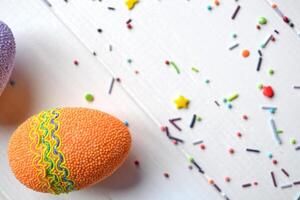 Colorful easter eggs bright sweet powder for easter cake on the white wooden table. Beautiful easter background. Easter card. Homemade holiday decor. photo