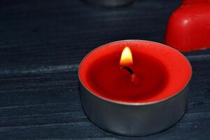 Candle light. Red candle on the table. photo