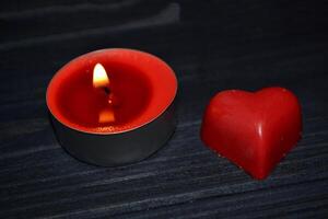 Candle light. Red candle on the table. photo