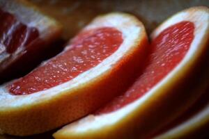 Slised grapefruit on the wooden table. photo