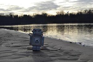 Bag in the form of a robot on the sand. photo
