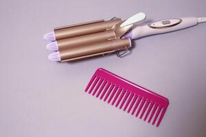 Curling iron for curls. Hair style. Hair care equipment. photo