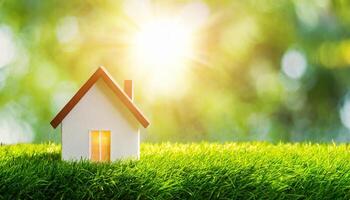 AI generated Copy space of home and life concept. Small model home on green grass with sunlight abstract background. photo