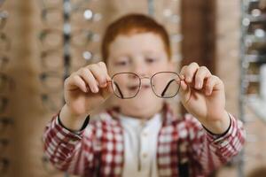 boy in glasses at optics store. photo