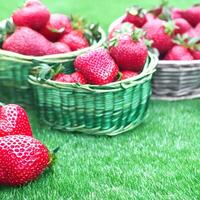 AI generated eap of fresh strawberries in bowl on white wooden background. Top view point. photo