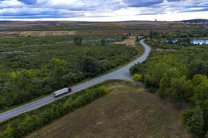 Aerial view from a drone of a truck on road. Transportation and infrastructure concept photo