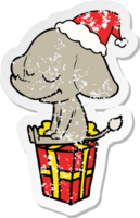 hand drawn distressed sticker cartoon of a smiling elephant wearing santa hat png