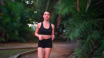 a woman running on a path through a park video