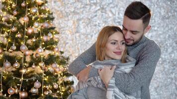 Couple decorating the Christmas tree together in the Christmas Eve video