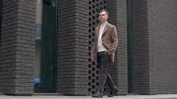 A businessman in a suit walking through the business center. Slow motion video