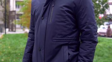 Close-up of a man in a blue jacket from the new collection on the street video