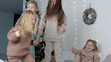 Children jumping near Christmas decorations video