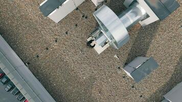 Maintenance of large ventilation industrial installations. The engineer inspects the ventilation installation on the roof of the enterprise, top view. video