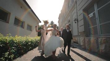 oyful Wedding Party Running Outside Venue, Bridal party in celebration, running outdoors with bride and groom. video