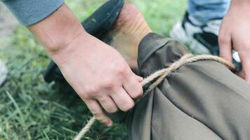 Close-up of a man's legs being tied with a rope. Abduction of husband. Detention of the robber. video