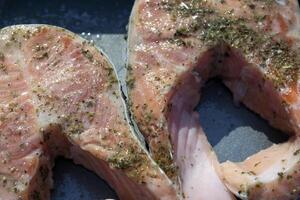 Preparation of trout in spices to roast on barbecue outdoor. photo