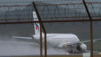 PHUKET, THAILAND - JANUARY 25, 2023. Airbus A320, HS-PPH of Bangkok Airways acceleration for takeoff at Phuket airport, rear view. Airplane take-off from wet runway with water spray video