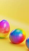 Three colorful eggs sitting on yellow surface with yellow background. Vertical looped animation video