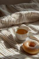 AI generated a cup of tea and a donut is shown on a bed to show the breakfast view photo