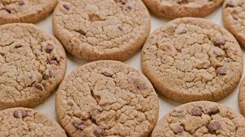 round chip cake cookies with chocolate on flat surface slow rotating loop video