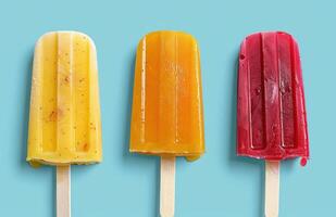 AI generated three colorful ice pops on a blue background photo