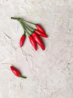 Photo taken from above of red hot peppers on a white table