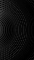 Black and white photo of circular object with black background. Vertical looped animation video