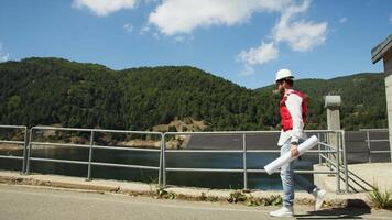 The profession of architect and designer walk near the new dam construction video