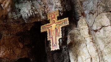 ancient Crucifix hanging from the top of a cavern video