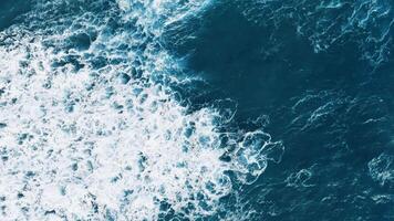 Foam of stormy ocean waves creating white shapes video