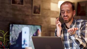 Businessman having an argument over the phone in home office during night hours. Serious businessman. video