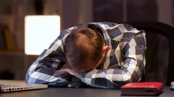 Tired businessman sleeping with head on desk in home office. Overworked entrepreneur. video