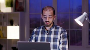 Businessman wearing a shirt during a video call on his laptop.Businessman working in his home office.