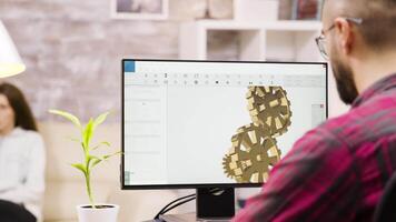 Male engineer working on a 3d design from home. Girlfriend in the background. video