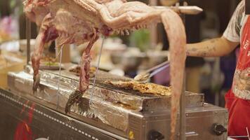 Grilled crocodile vendor at the night food market at Bangkok, Thailand video