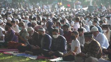 Bali, Indonesië, mei 2 2022 - moslims verzamelen vieren eid al-fitr salah bidden in een park in Denpasar video