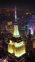 Stunning New York at night scenery. Eye-catching sight of vibrant metropolis at the backdrop of dark sky. Vertical video