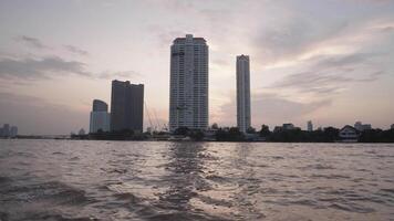 Bangkok, Thailand circa 2023 - The evening atmosphere on a boat on the Chao Phraya River - with the backdrop of Bangkok skyscrapers is a truly magical sight video