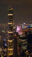 Billions of lights in New York cityscape at nighttime. Famous skyscrapers with lit windows. Top view. Vertical video