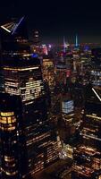 Multiple lights reflecting in the mirror windows of famous New York skyscrapers. Endless cityscape of stunning metropolis. Aerial view. Vertical video