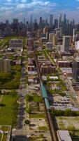 Beautiful scenic picture of modern Chicago on sunny daytime. Drone descending over the underground railways. Skyscrapers at backdrop. Vertical video