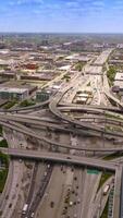 Stunning road system in Chicago, Illinois. Multiple highways, roundabouts and loops at the traffic of metropolis. Beautiful city panorama from above. Vertical video