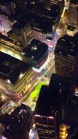 Radiant buildings of vibrant New York. City lights of beautiful metropolis at night. View from above. Vertical video