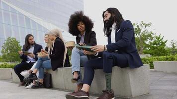 a group of people sitting on a bench video